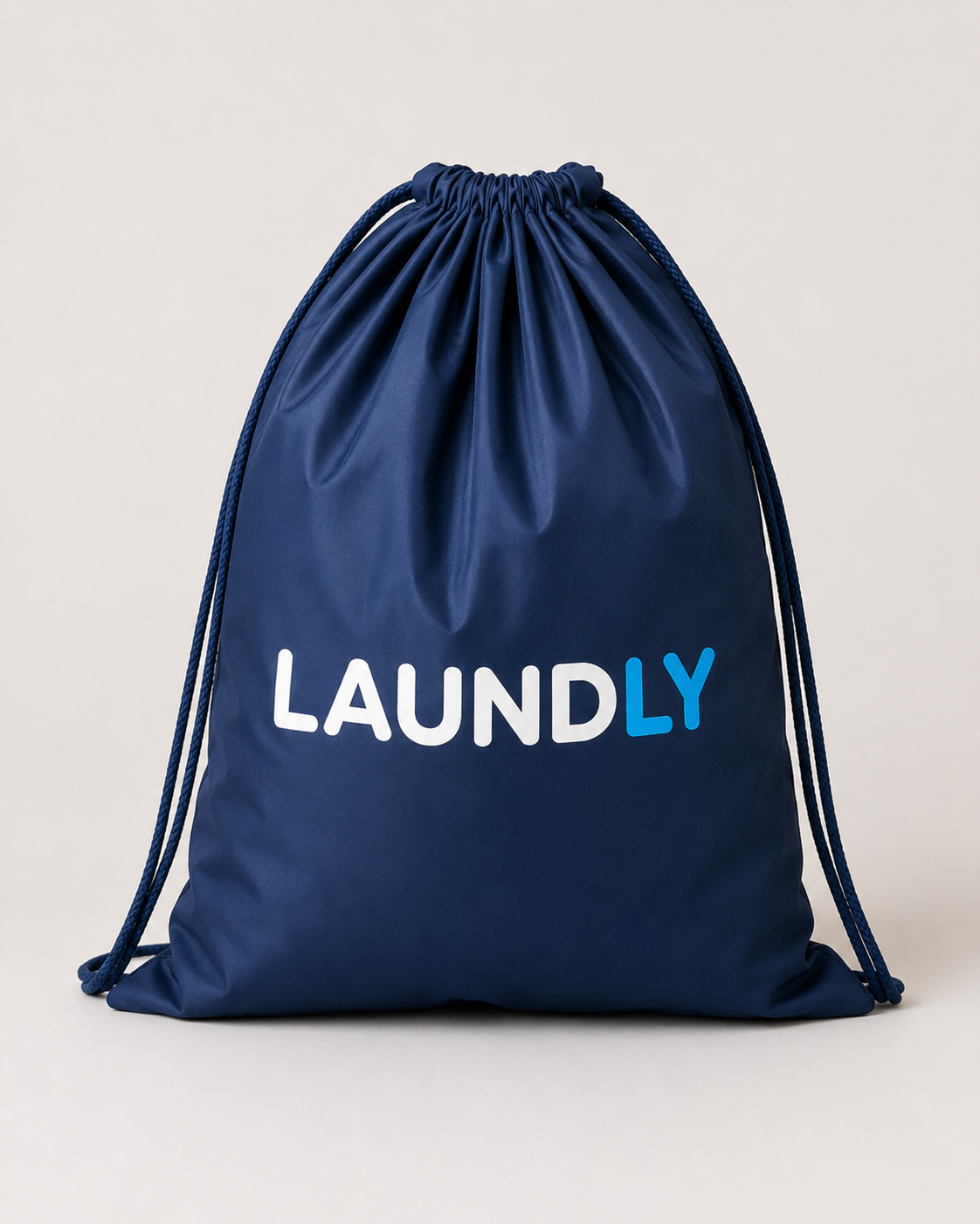 The Laundly reusable drawstring laundry bag in navy blue with the Laundly wordmark